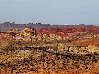 Road running through the otherworldly multicoloured, barren landscape of the Valley of Fire State Park, Nevada. 