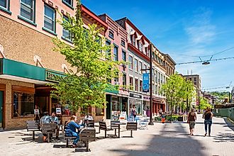 People have lunch and walk in a pedestrian area of downtown Ithaca, New York State