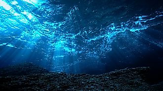 Underwater photo of rays light in the deep blue ocean.