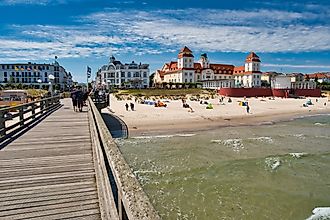 View of the pier with historic building along a sandy beach in Binz, Germany. Image credit: Rico Markus / Shutterstock.com
