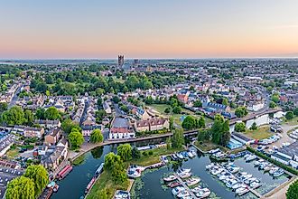 Drone view of Ely Cathedral with Ely Marina and Great Ouse River in foreground, Ely, Cambridgeshire, England.
