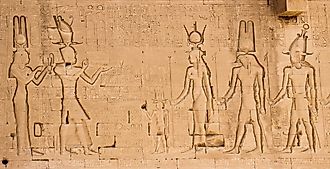 The south wall of the temple of Hathor at Dendera with lion-headed waterspouts. Cleopatra and her son Caesarian (on the left side)