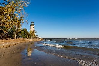 The historic Pelee Island Lighthouse, built in 1833, reflecting on its Lake Erie shoreline.