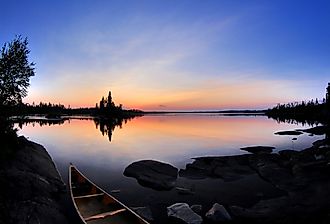 Calm summer day in northern Saskatchewan. In the Churchill River system. Image credit Curtis N. via Shutterstock.