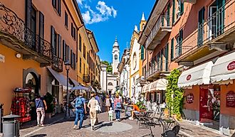 A colorful narrow street of shops and cafes in the medieval old town center of Menaggio, Italy, on the shores of Lake Como. Editorial credit: Kirk Fisher / Shutterstock.com