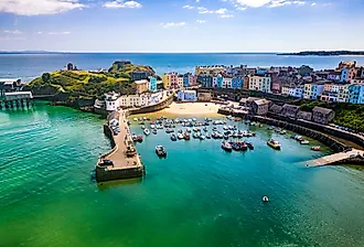 Aerial view of colorful buildings around a small harbor, in Tenby, Wales, UK.