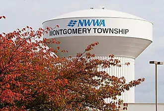 The water tower of NWWA Montgomery Township with the fall foliage, Pennsylvania. Image credit Khairil Azhar Junos via Shutterstock