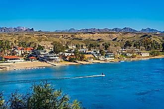 A jet skier speeds by riverfront property on the Colorado River in Bullhead City, Arizona. Image credit: Felipe Sanchez / Shutterstock.com