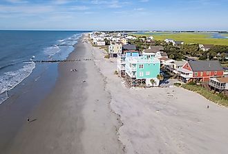 Aerial view of homes along the sandy beach in Folly Beach, South Carolina.