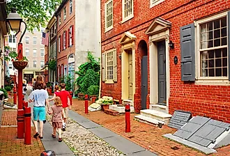 A family strolls down Elfreth's Alley, Philadelphia, the oldest street in continuous use in the United States.