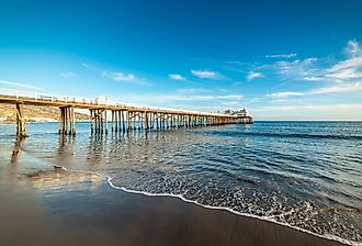 Malibu pier under a blue sky at sunset. California, USA