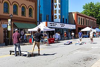 Four young men playing cornhole or corn toss in Elkin, North Carolina. Image credit:  J. Michael Jones / Shutterstock.com.