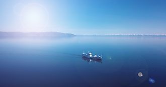 Aerial view of a ship floating in the water. Lake Baikal. Blue water.