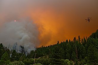 A helicopter moves above  a section of the McFarland Fire in the Shasta-Trinity National Forest in California, Editorial credit: DBrownPhotos / Shutterstock.com