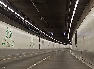 Seattle SR 99 Tunnel Interior Roadway with Curving Lanes and Emergency Exit Signs