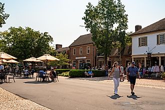 Street scene from historic Williamsburg Virginia at Merchants Square with people visible.