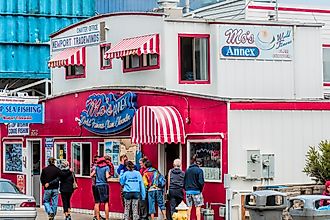 Dee Browning via Shutterstock. Newport, Oregon,USA: Tourist stand in front of Moe's seafood annex in downtown Newport.