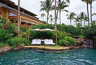 View of the Four Seasons Resort Lanai, an upscale luxury hotel next to Hulopoe Beach on the Pacific Ocean. Image credit EQRoy via Shutterstock.