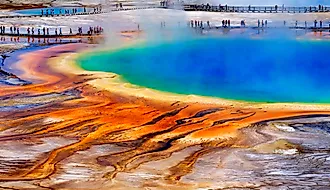 Grand Prismatice Spring in Yellowstone National Park with tourists viewing the spectacular natural scene