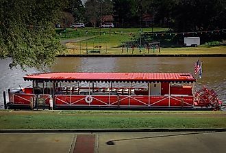 A boat on the Cane River below the town strip, Natchitoches, Louisiana. Image credit Sabrina Janelle Gordon via Shutterstock