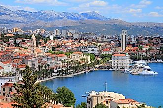 The stately Old Town facade of Split, Croatia, backdropped by the Dinaric Alps and met by the Adriatic Sea.