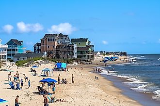 View of people and vacation homes on the beach as seen from the Rodanthe Pier in the Outer Banks