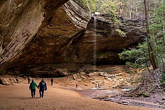 Tourists visit Ash Cave in Southeast Ohio at Hocking Hills State Park.. Image credit: Arthurgphotography / Shutterstock.com.