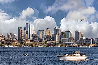 Seattle, Washington, city skyline from Lake Union with white clouds and blue sky.