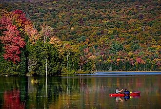 Kayakers on Lake Eden, Vermont, in the fall. Image credit T photography via Shutterstock.