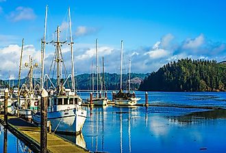 Old small fishing boat in harbor in Florence, Oregon. Image credit NeungPH via Shutterstock