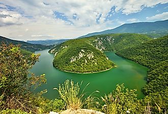 Aerial photo of the green waters of the bending Drava River through Slovenia.