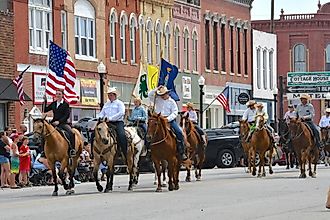 Horseback riders in a parade in Council Grove, Kansas. Image credit Mark Reinstein via Shutterstock