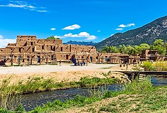 Taos Pueblo with mountains in the background. Image credit Gimas via Shutterstock. 