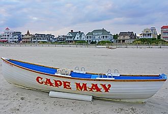 Boat with a Cape May sign on the beach in Cape May, New Jersey. Image credit EQRoy via Shutterstock