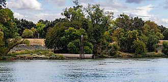 Levee on sacramento river panorama with drainage pipe 