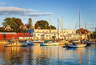 Beautiful harbor with anchored boats at sunset in Camden, Maine. 