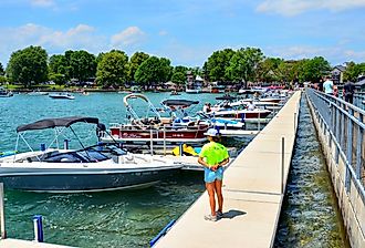 Pier and luxury boats docked in the Skaneateles Lake, New York. Image credit PQK via Shutterstock