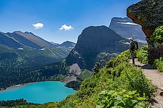 A hiker admiring the scenic landscape in Glacier National Park, Montana.