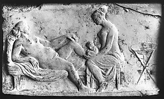 Ancient Roman carving of a midwife. Image by Wellcome Images. CC BY 4.0 <https://creativecommons.org/licenses/by/4.0>, via Wikimedia Commons