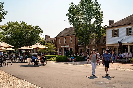 Street scene from historic Williamsburg Virginia at Merchants Square with people visible.