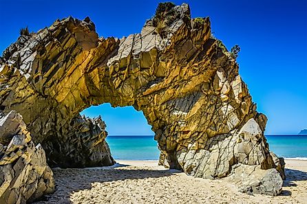 The Arch is a distinctive rock formation located at the west end of Mile Beach at the north end of The Neck that separates the north and south half of Bruny Island, Tasmania, Australia