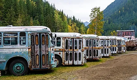 A collection of old trolley city buses in the ghost town of Sandon, British Columbia, Canada. Editorial credit: Nalidsa / Shutterstock.com