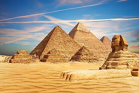 The Great Sphinx sits majestically by the Pyramids of Egypt in the Giza desert.