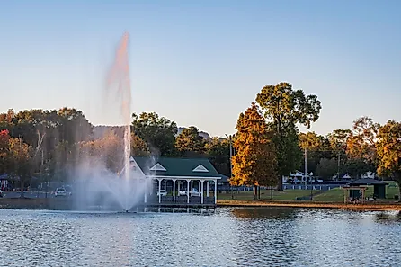 Fountain and gazebo in late afternoon at Oxford Lake Park in Oxford, Alabama. Image credit: JNix / Shutterstock.com.