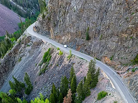 A lone vehicle drives along the dangerous Million Dollar Highway at Ouray, Colorado