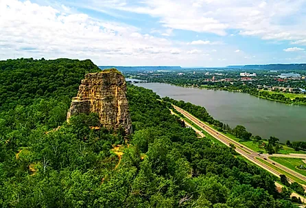 Sugar Loaf Bluff and the highway and lake in Winona, Minnesota during the summer.