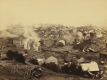 General view of Johnstown from high ground after the flood of May 31st, 1889. Horse drawn wagons and men work in the central mid-ground, possibly recovering bodies Editorial credit: Everett Collection / Shutterstock.com 