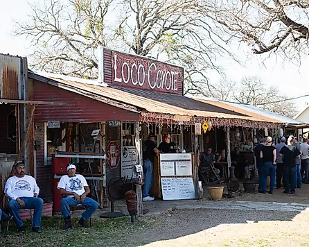 People at Loco Coyote Bar and Grill In Glen Rose Texas on a Sunny Day, via jmanaugh3 / Shutterstock.com
