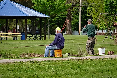 A group enjoying some lake fishing in Tomah, Wisconsin as part of a community event. Editorial credit: Aaron of L.A. Photography / Shutterstock.com