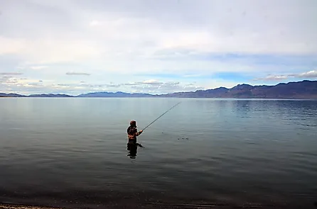 A fisherman fishing in Pyramid Lake which is a large natural lake and a world-class fishery in Nevada. Pyramid Lake, Nevada, United States Editorial credit: Daniel L. Locke / Shutterstock.com